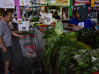 Activities of visitors and vegetable traders at Oro Oro Dowo traditional market in Malang, East Java, Indonesia, on September 14, 2024. This...