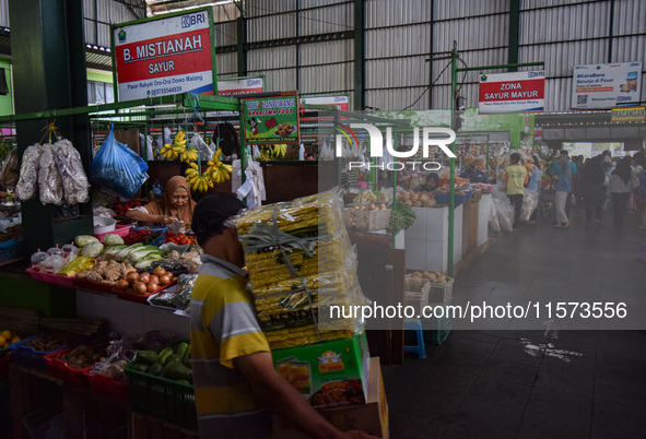 Activities of visitors and vegetable traders at Oro Oro Dowo traditional market in Malang, East Java, Indonesia, on September 14, 2024. This...