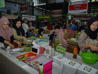 Young people sell Indonesian traditional pancake products (Klepon) at Oro Oro Dowo traditional market in Malang, East Java, Indonesia, on Se...