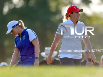 GAINESVILLE, VIRGINIA - SEPTEMBER 14: Lauren Coughlin (R, foreground) of the United States walks on the 3rd green past Maja Stark  (L, backg...