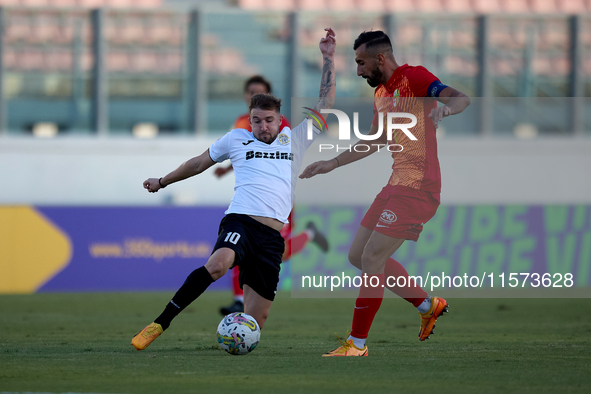 Jurgen Degabriele (L) of Hibernians competes for the ball with Kurt Zammit (R) of Birkirkara during the Malta 360 Sports Premier League socc...