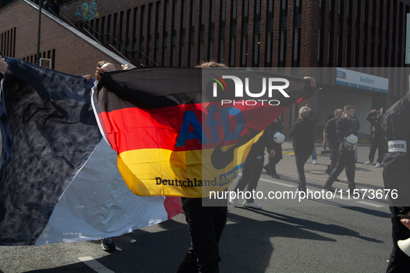 A protester with an AFD flag is seen as dozens of counter-protesters from several right-wing groups organize a demonstration against the ann...