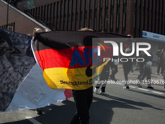 A protester with an AFD flag is seen as dozens of counter-protesters from several right-wing groups organize a demonstration against the ann...