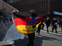 A protester with an AFD flag is seen as dozens of counter-protesters from several right-wing groups organize a demonstration against the ann...