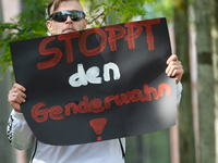 A protester holds a sign reading ''Stop Gender Choice'' as dozens of counter-protesters from several right-wing groups organize a demonstrat...