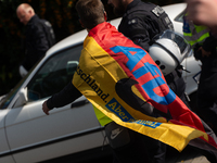 A protester with an AFD flag is seen as dozens of counter-protesters from several right-wing groups organize a demonstration against the ann...