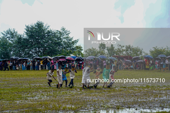 The Nepalese community wears traditional clothes and celebrates the Dhan Ropai festival in Panchthar, Nepal, on September 14, 2024. 