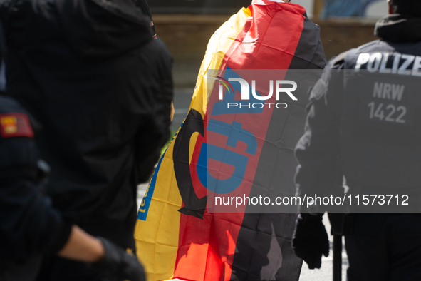 A protester with an AFD flag is seen as dozens of counter-protesters from several right-wing groups organize a demonstration against the ann...