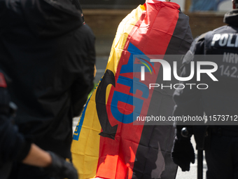 A protester with an AFD flag is seen as dozens of counter-protesters from several right-wing groups organize a demonstration against the ann...