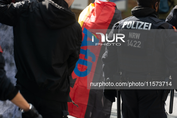 A protester with an AFD flag is seen as dozens of counter-protesters from several right-wing groups organize a demonstration against the ann...