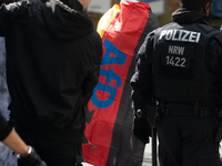 A protester with an AFD flag is seen as dozens of counter-protesters from several right-wing groups organize a demonstration against the ann...