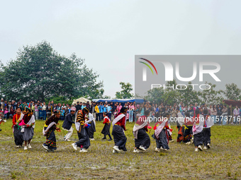 The Nepalese community wears traditional clothes and celebrates the Dhan Ropai festival in Panchthar, Nepal, on September 14, 2024. (