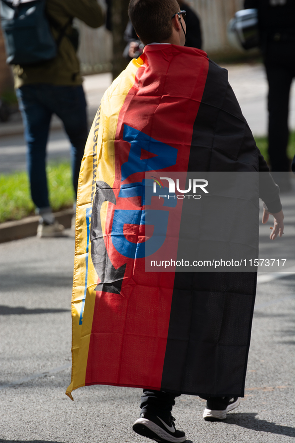 A protester with an AFD flag is seen as dozens of counter-protesters from several right-wing groups organize a demonstration against the ann...