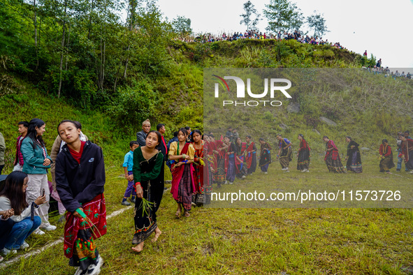 The Nepalese community wears traditional clothes and celebrates the Dhan Ropai festival in Panchthar, Nepal, on September 14, 2024. 