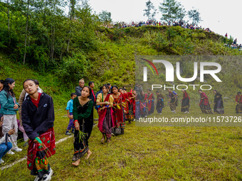 The Nepalese community wears traditional clothes and celebrates the Dhan Ropai festival in Panchthar, Nepal, on September 14, 2024. (