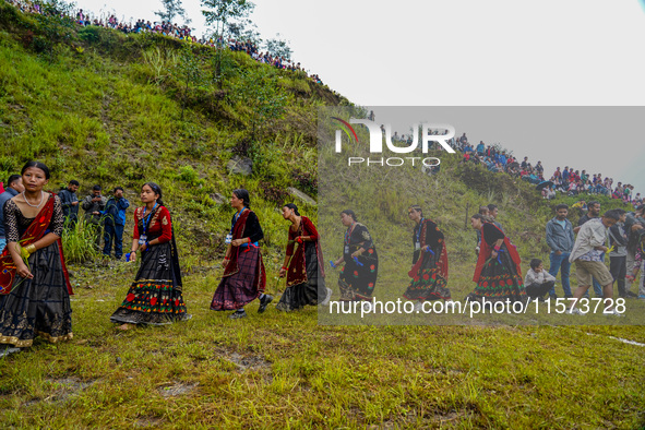 The Nepalese community wears traditional clothes and celebrates the Dhan Ropai festival in Panchthar, Nepal, on September 14, 2024. 