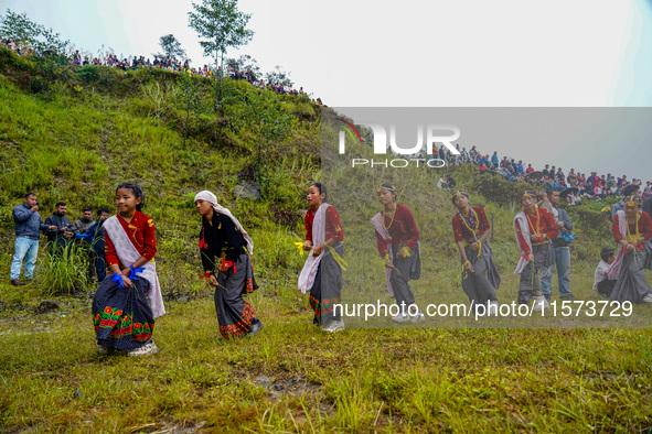 The Nepalese community wears traditional clothes and celebrates the Dhan Ropai festival in Panchthar, Nepal, on September 14, 2024. 