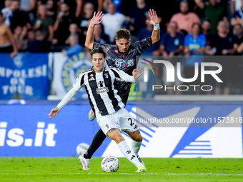 Nicolo' Fagioli of Juventus FC and Sebastiano Esposito of Empoli FC compete for the ball during the Serie A Enilive match between Empoli FC...