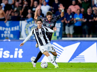 Nicolo' Fagioli of Juventus FC and Sebastiano Esposito of Empoli FC compete for the ball during the Serie A Enilive match between Empoli FC...