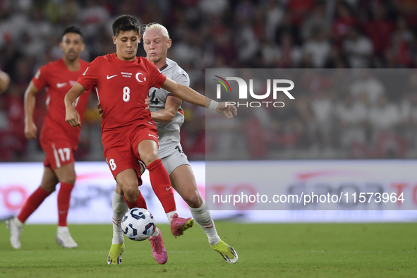 Arda Guler of Turkey and Kolbeinn Finnsson of Iceland  during the UEFA Nations League 2024/25 League B Group B4 match between Turkiye and Ic...