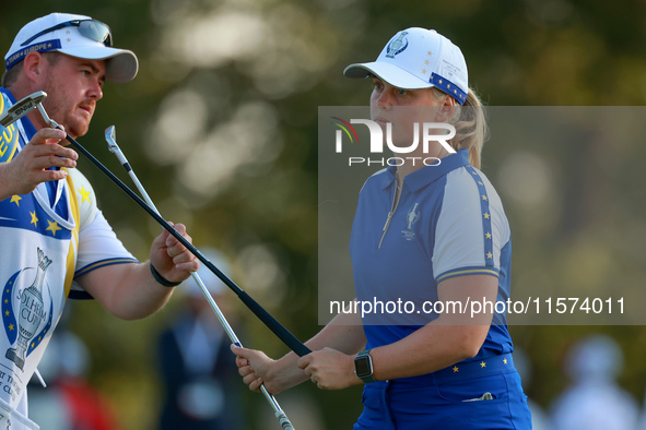 GAINESVILLE, VIRGINIA - SEPTEMBER 14: Maja Stark of Team Europe exchanges clubs with her caddie on the 3rd green during Day Two of the Solhe...