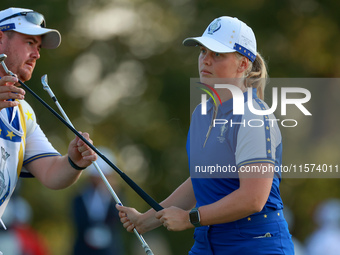 GAINESVILLE, VIRGINIA - SEPTEMBER 14: Maja Stark of Team Europe exchanges clubs with her caddie on the 3rd green during Day Two of the Solhe...