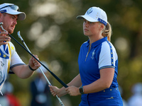 GAINESVILLE, VIRGINIA - SEPTEMBER 14: Maja Stark of Team Europe exchanges clubs with her caddie on the 3rd green during Day Two of the Solhe...