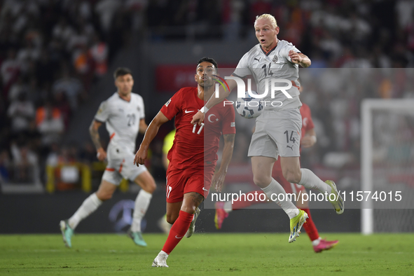 Irfan Can Kahveci of Turkey and Kolbeinn Finnsson of Iceland  during the UEFA Nations League 2024/25 League B Group B4 match between Turkiye...