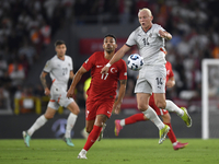 Irfan Can Kahveci of Turkey and Kolbeinn Finnsson of Iceland  during the UEFA Nations League 2024/25 League B Group B4 match between Turkiye...