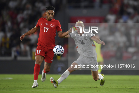 Irfan Can Kahveci of Turkey and Kolbeinn Finnsson of Iceland  during the UEFA Nations League 2024/25 League B Group B4 match between Turkiye...