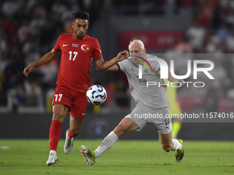 Irfan Can Kahveci of Turkey and Kolbeinn Finnsson of Iceland  during the UEFA Nations League 2024/25 League B Group B4 match between Turkiye...