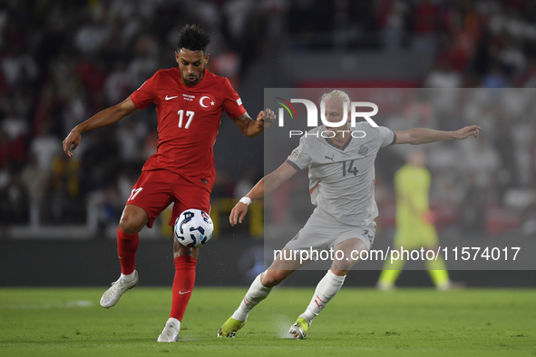 Irfan Can Kahveci of Turkey and Kolbeinn Finnsson of Iceland  during the UEFA Nations League 2024/25 League B Group B4 match between Turkiye...