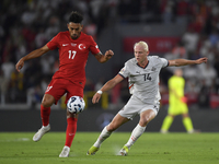 Irfan Can Kahveci of Turkey and Kolbeinn Finnsson of Iceland  during the UEFA Nations League 2024/25 League B Group B4 match between Turkiye...