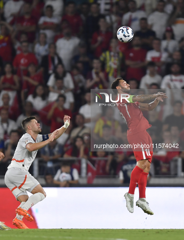 Hakan Calhanoglu of Turkey and Johann Gudmundsson of Iceland   during the UEFA Nations League 2024/25 League B Group B4 match between Turkiy...