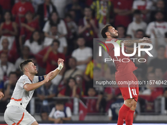 Hakan Calhanoglu of Turkey and Johann Gudmundsson of Iceland   during the UEFA Nations League 2024/25 League B Group B4 match between Turkiy...