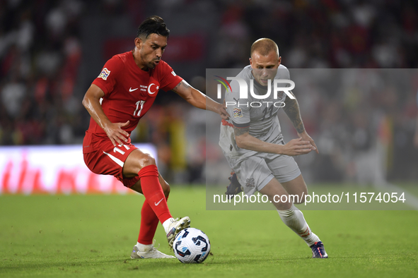 Irfan Can Kahveci of Turkey and Jon Dagur Thorsteinsson of Iceland   during the UEFA Nations League 2024/25 League B Group B4 match between...