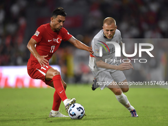 Irfan Can Kahveci of Turkey and Jon Dagur Thorsteinsson of Iceland   during the UEFA Nations League 2024/25 League B Group B4 match between...