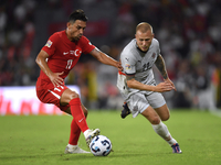 Irfan Can Kahveci of Turkey and Jon Dagur Thorsteinsson of Iceland   during the UEFA Nations League 2024/25 League B Group B4 match between...