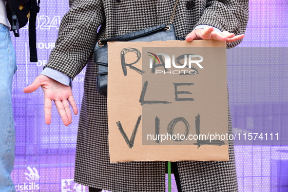 Several women and men gather with placards to support Gisele Pelicot and all rape victims in Lyon, France, on September 14, 2024. 