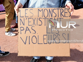 Several women and men gather with placards to support Gisele Pelicot and all rape victims in Lyon, France, on September 14, 2024. (