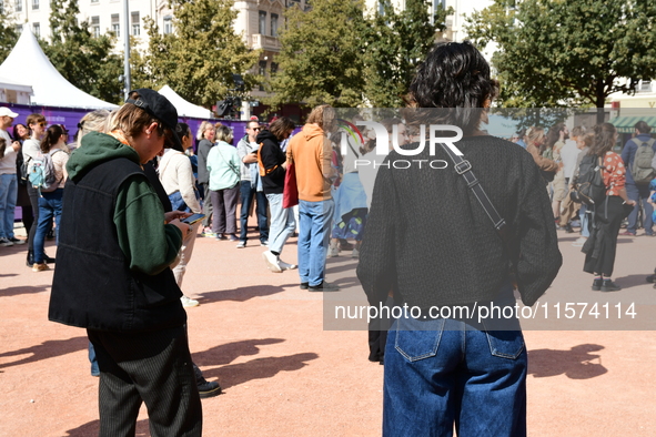 Several women and men gather with placards to support Gisele Pelicot and all rape victims in Lyon, France, on September 14, 2024. 