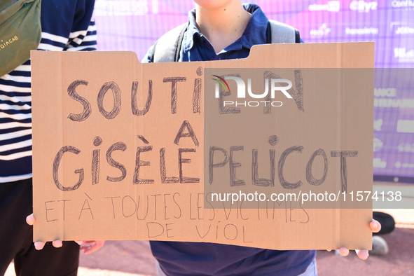 Several women and men gather with placards to support Gisele Pelicot and all rape victims in Lyon, France, on September 14, 2024. 