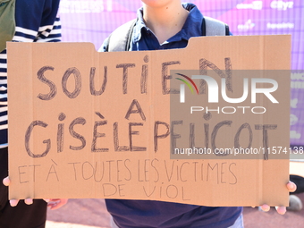 Several women and men gather with placards to support Gisele Pelicot and all rape victims in Lyon, France, on September 14, 2024. (