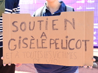 Several women and men gather with placards to support Gisele Pelicot and all rape victims in Lyon, France, on September 14, 2024. (