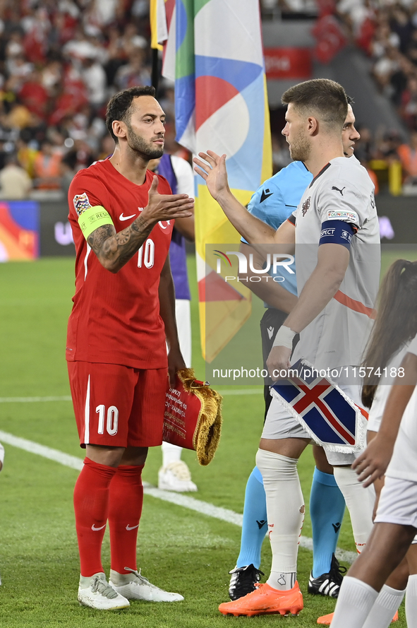 Hakan Calhanoglu of Turkey and Johann Gudmundsson of Iceland   during the UEFA Nations League 2024/25 League B Group B4 match between Turkiy...