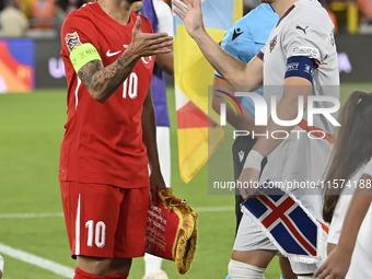 Hakan Calhanoglu of Turkey and Johann Gudmundsson of Iceland   during the UEFA Nations League 2024/25 League B Group B4 match between Turkiy...