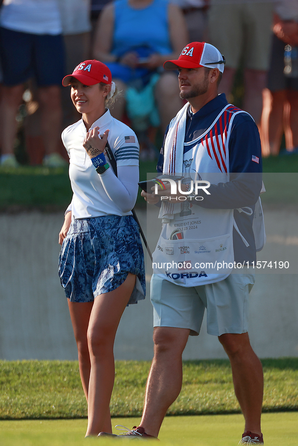 GAINESVILLE, VIRGINIA - SEPTEMBER 14: Nelly Korda of the United States waits with her caddie on the 7th green during Day Two of the Solheim...