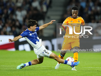 Vinicius Junior left winger of Real Madrid and Brazil and Aramburu of Real Sociedad and Spain controls the ball o during the La Liga match b...