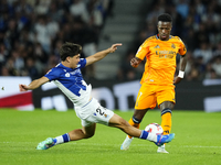 Vinicius Junior left winger of Real Madrid and Brazil and Aramburu of Real Sociedad and Spain controls the ball o during the La Liga match b...