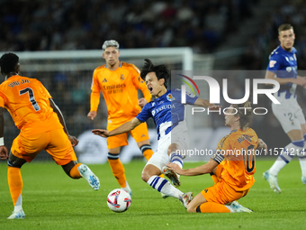 Takefusa Kubo right winger of Real Sociedad and Japan and Luka Modric central midfield of Real Madrid and Croatia compete for the ball durin...